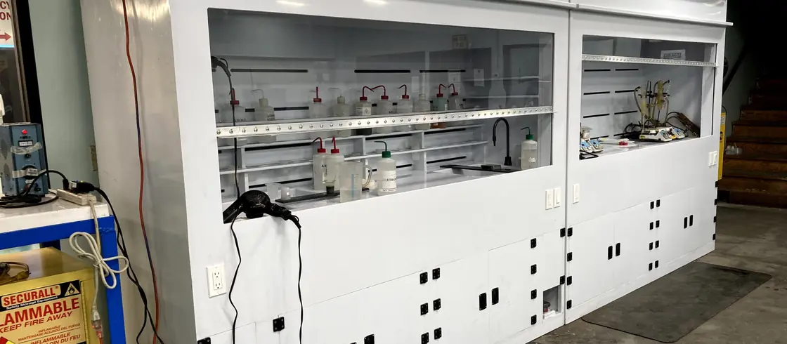 Custom white polypropylene wet bench with fume hood built for a chemical process line